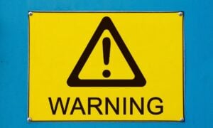 Big yellow sign that reads "Warning"